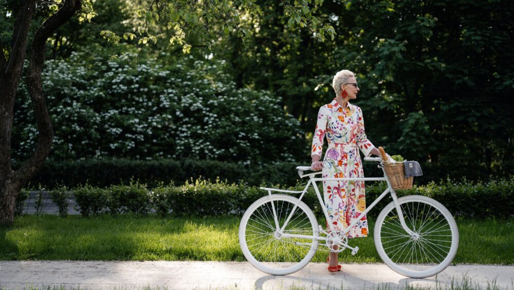 Fashionable senior woman with bicycle